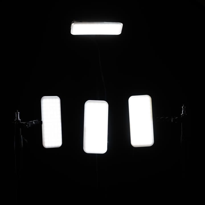 Four SLITE.pop units on stands in a dark room, one above and three in a row below
